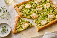 Thin tart topped with zucchini ribbons and goat cheese